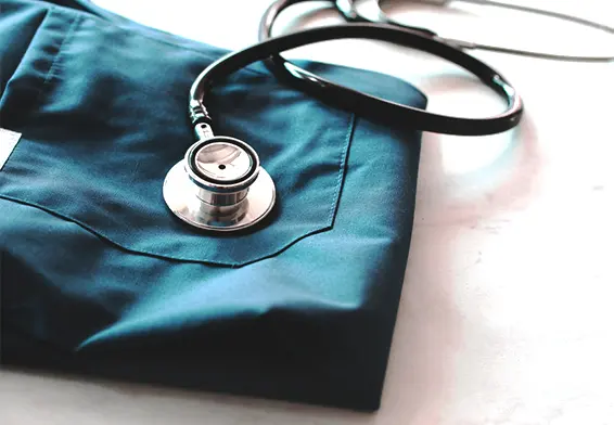 Close-up of a stethoscope resting on a medical scrub top