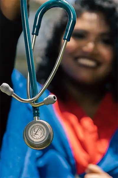 Smiling healthcare professional holding a stethoscope
